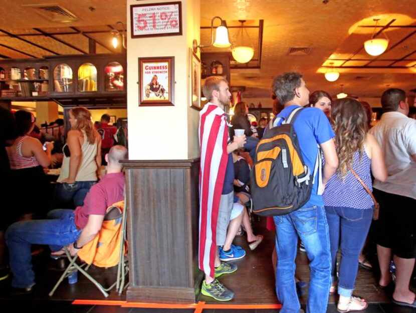 
Soccer fans staked out places  close to the screen during a watching party for the World...