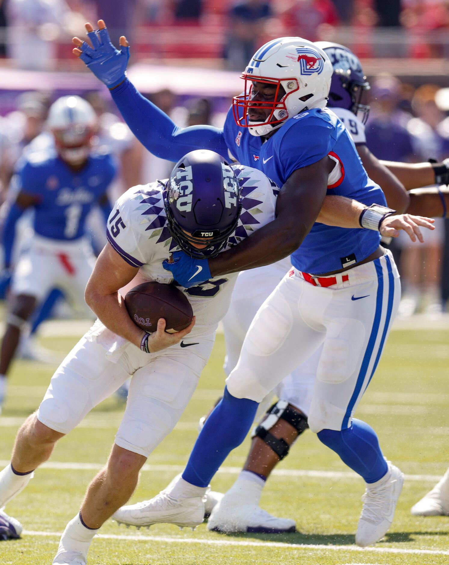 SMU defensive end Nelson Paul (9) sacks TCU quarterback Max Duggan (15) during the first...