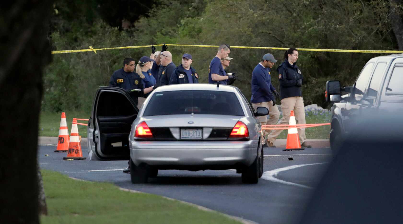 Officials work and stage near the site of Sunday's deadly explosion on Monday.