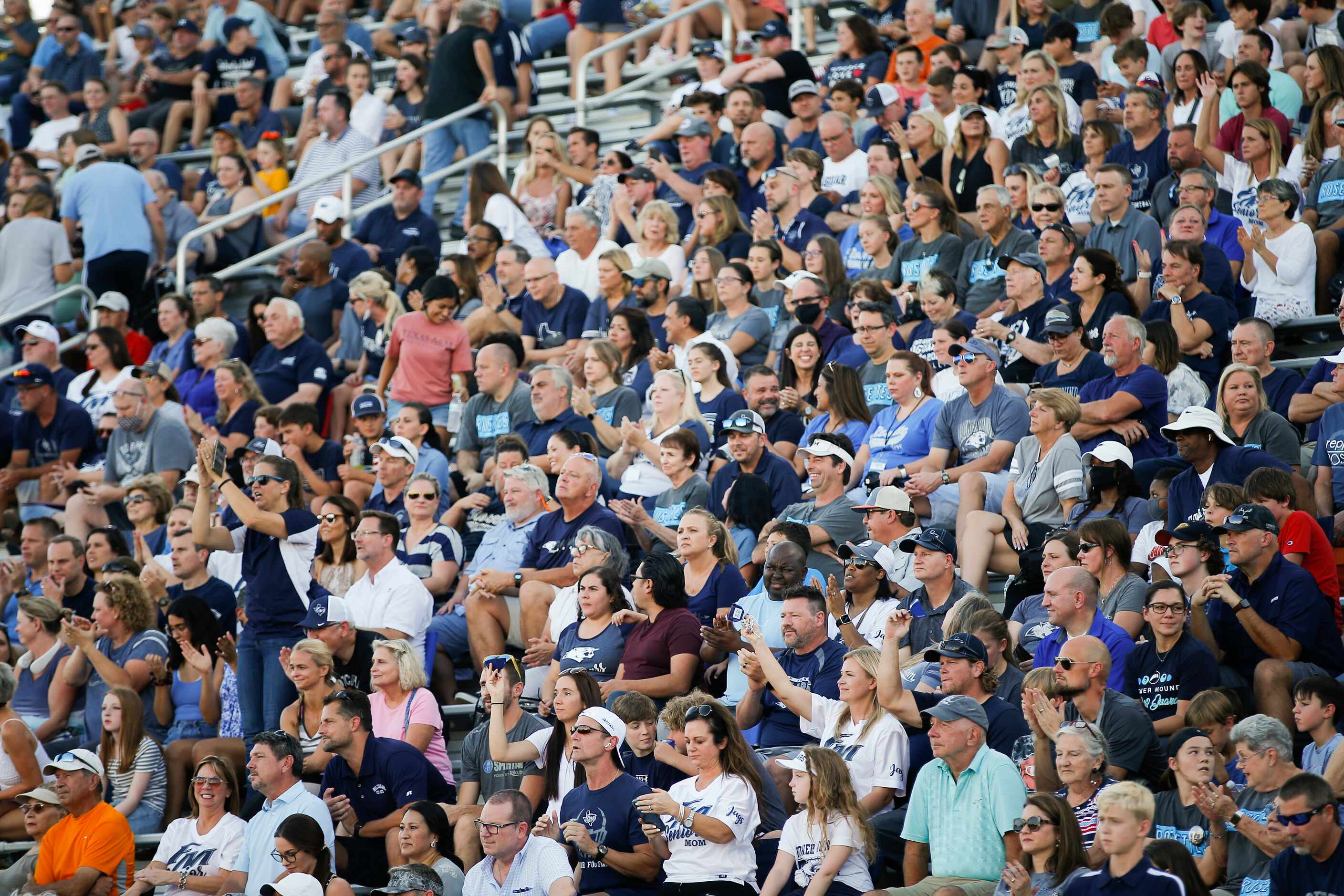 Flower Mound football fans cheer  during the first half of a high school football game at...