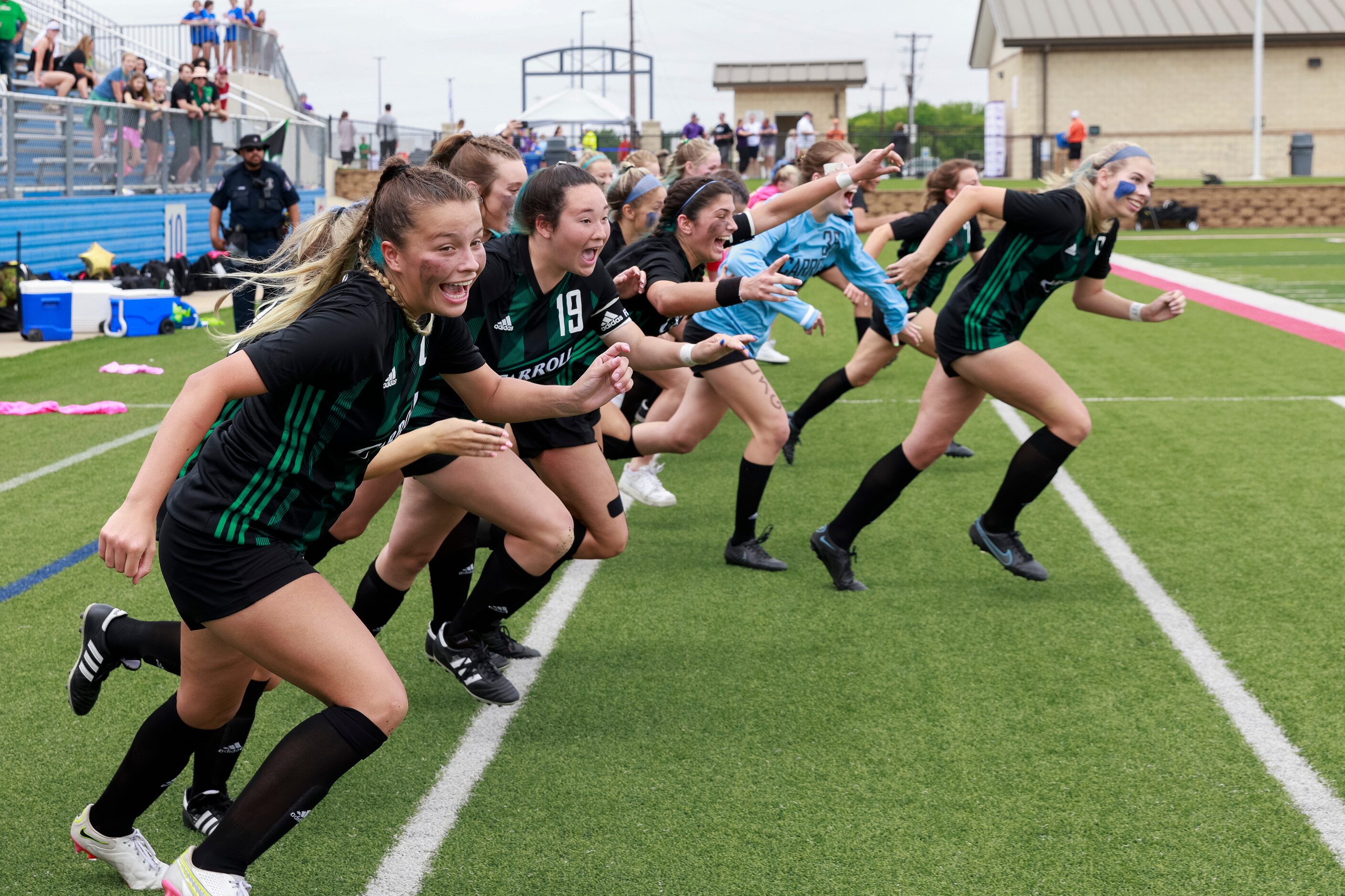 Southlake Carroll players rush the field after defeating Austin Westlake in a Class 6A girls...