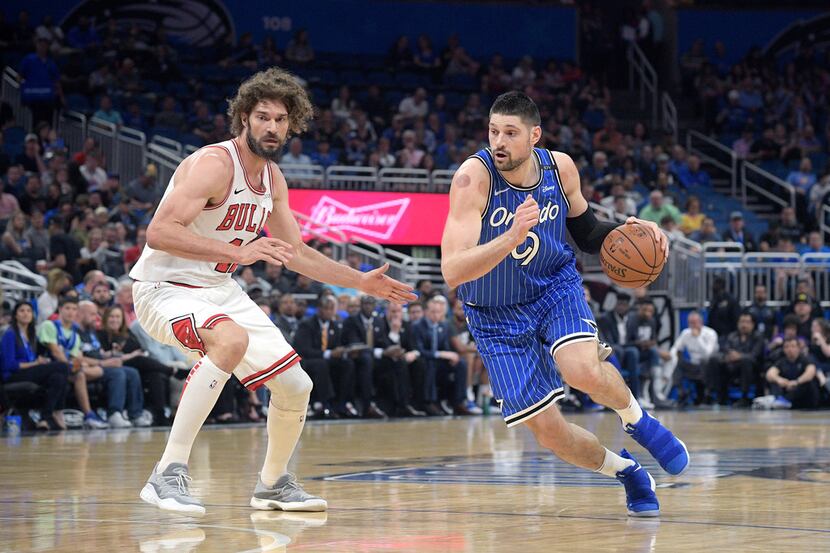 Orlando Magic center Nikola Vucevic (9) drives to the basket in front of Chicago Bulls...