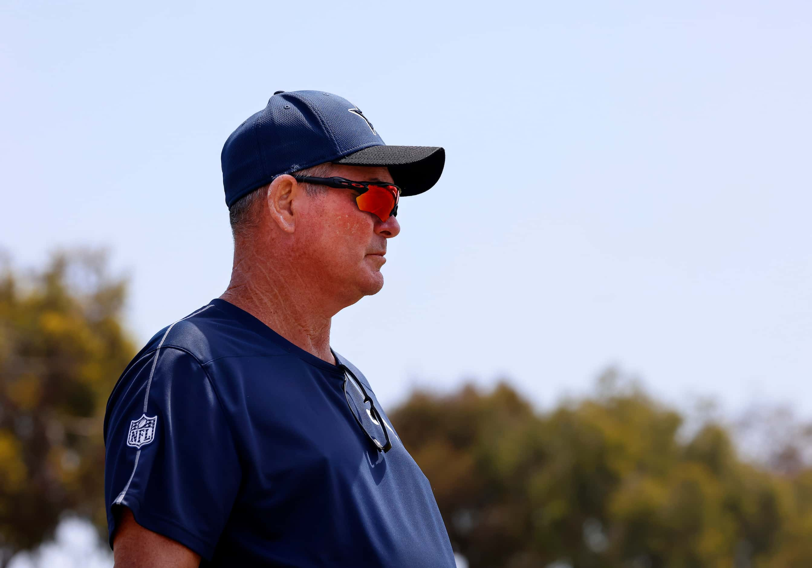 Dallas Cowboys defensive coordinator Mike Zimmer walks the sideline during 7-on-7 plays at...