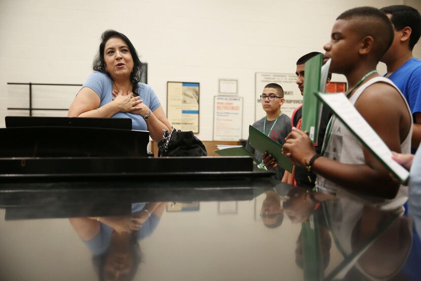 Camp instructor Michelle Quintana gives voice lessons to campers at the University of North...