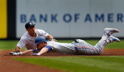 Texas Rangers' Corey Seager is tagged out by New York Yankees shortstop Anthony Volpe at...