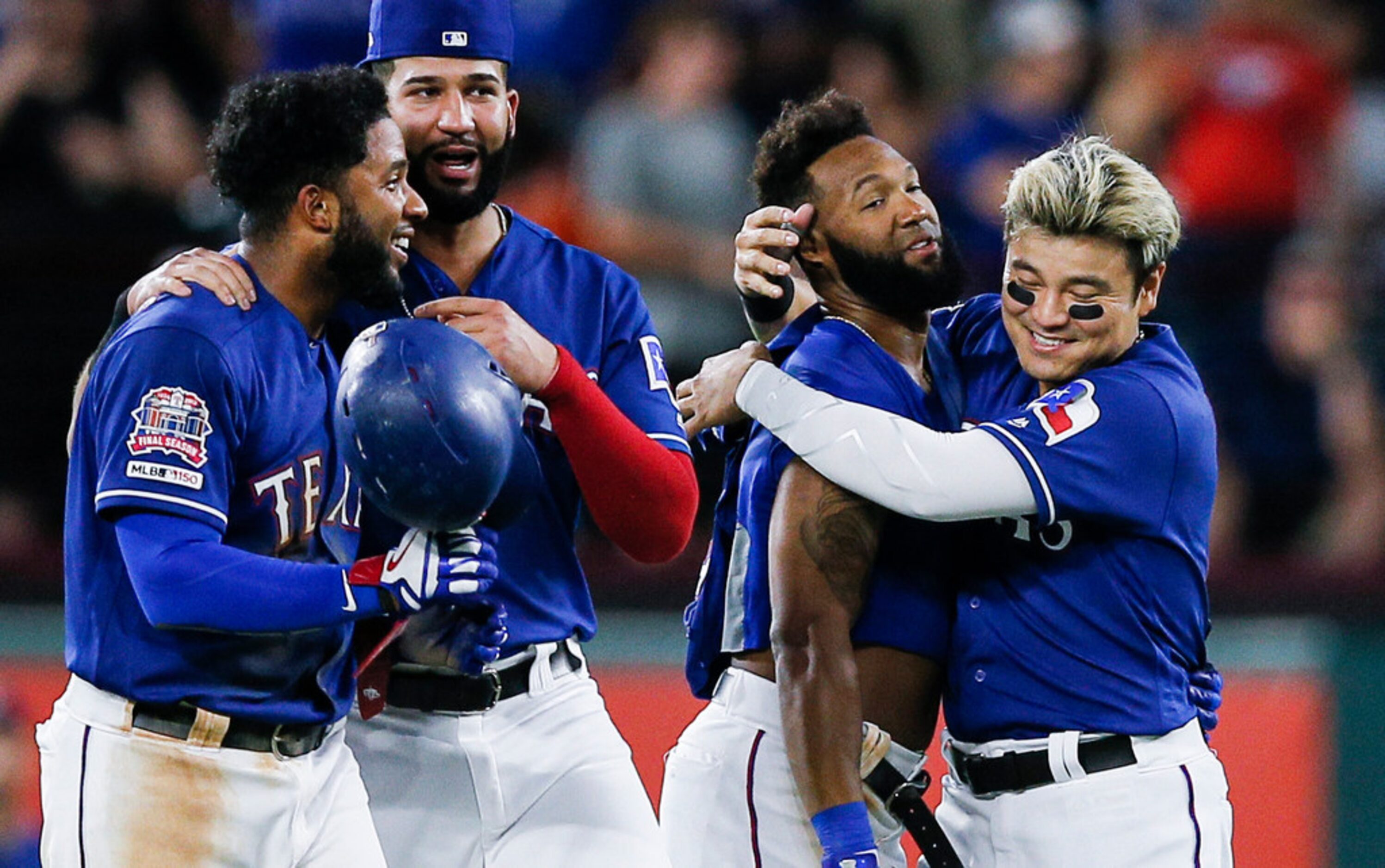 Texas Rangers' Danny Santana, second from right, is congratulated by Shin-Soo Choo after...