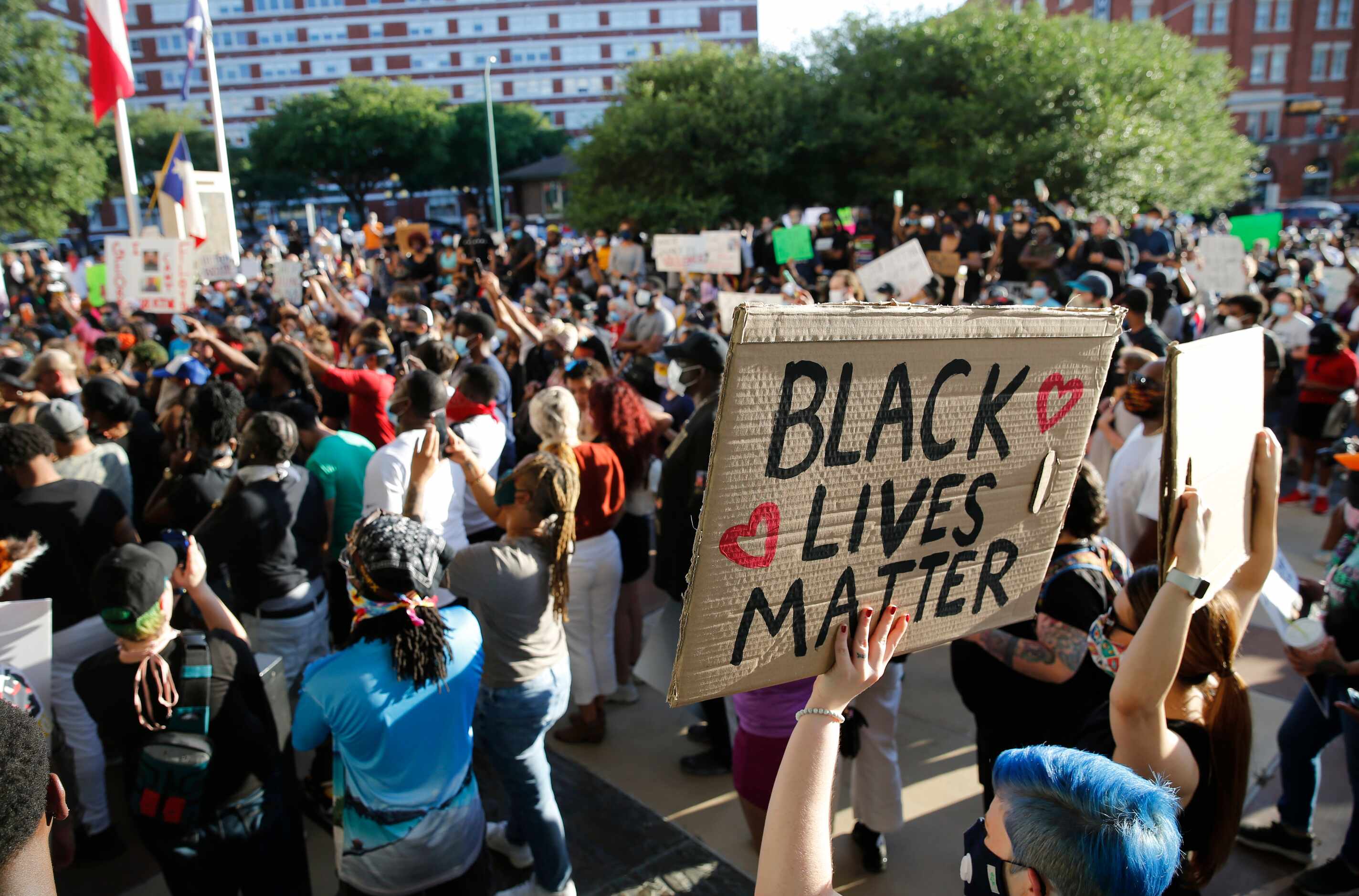Protesters rally during a demonstration against police brutality in front of Dallas Police...
