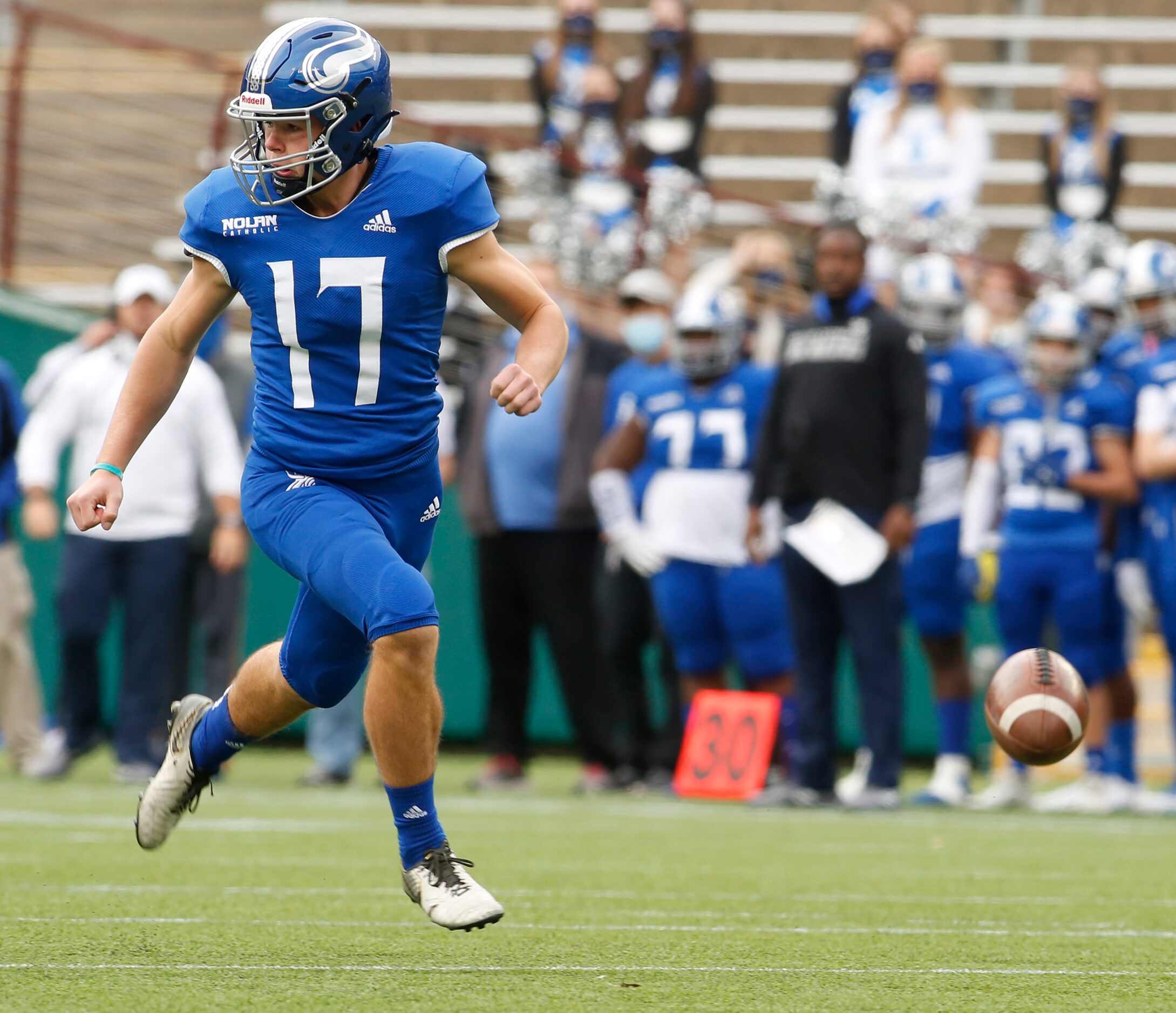 Fort Worth Nolan punter Riley Riethman (17) scampers after an errant snap from center sailed...