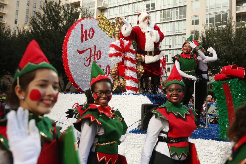 Santa Claus greets the crowd during the Dallas Holiday Parade through downtown Dallas...