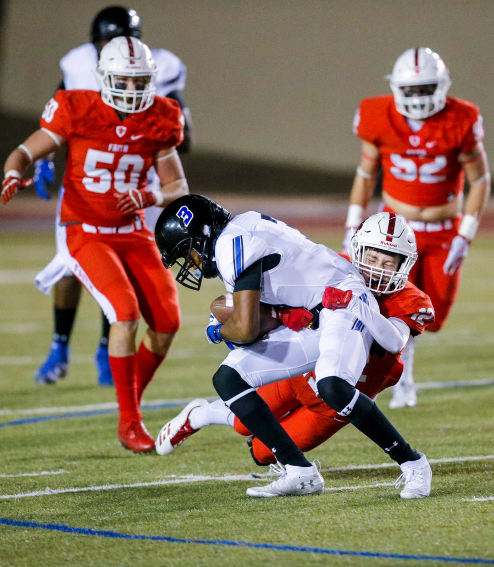 TXHSFB Grapevine Faith junior wide receiver Kaleb Rysavy (12) tackles Trinity Christian...