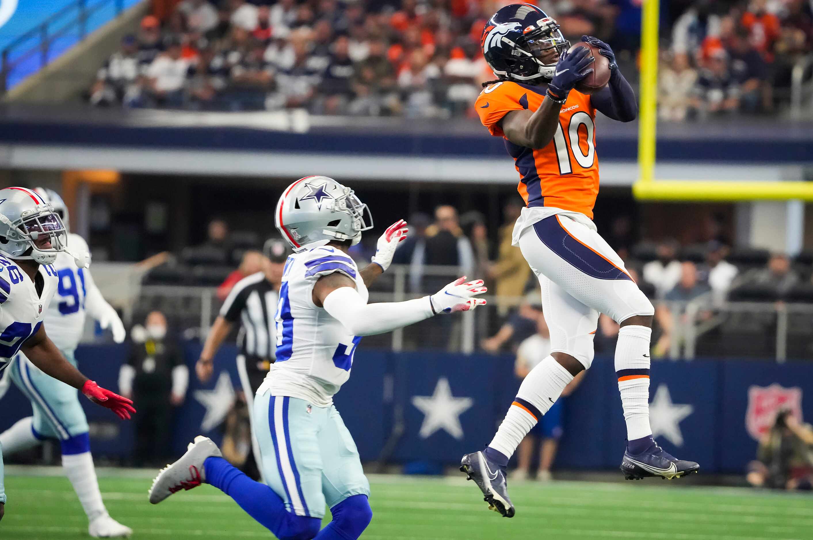 Denver Broncos wide receiver Jerry Jeudy (10) makes a catch over Dallas Cowboys cornerback...