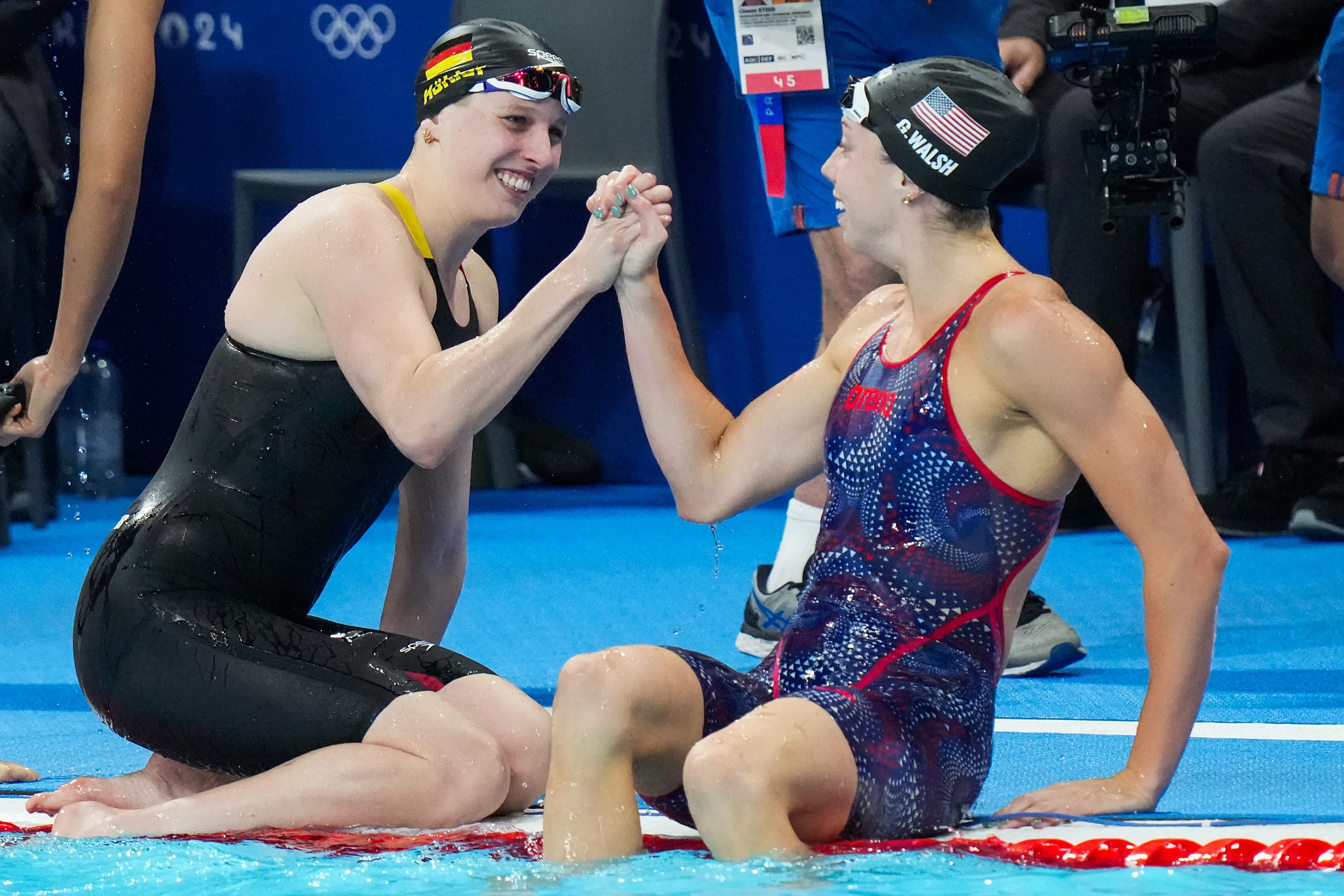 Gretchen Walsh of the United States (right) celebrates with Angelina Koehler of Germany...