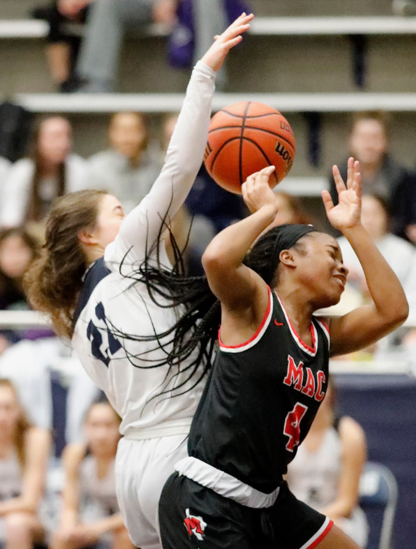 Irving MacArthur High School guard Morgan Browning (4) has a shot attempt blocked by Flower...