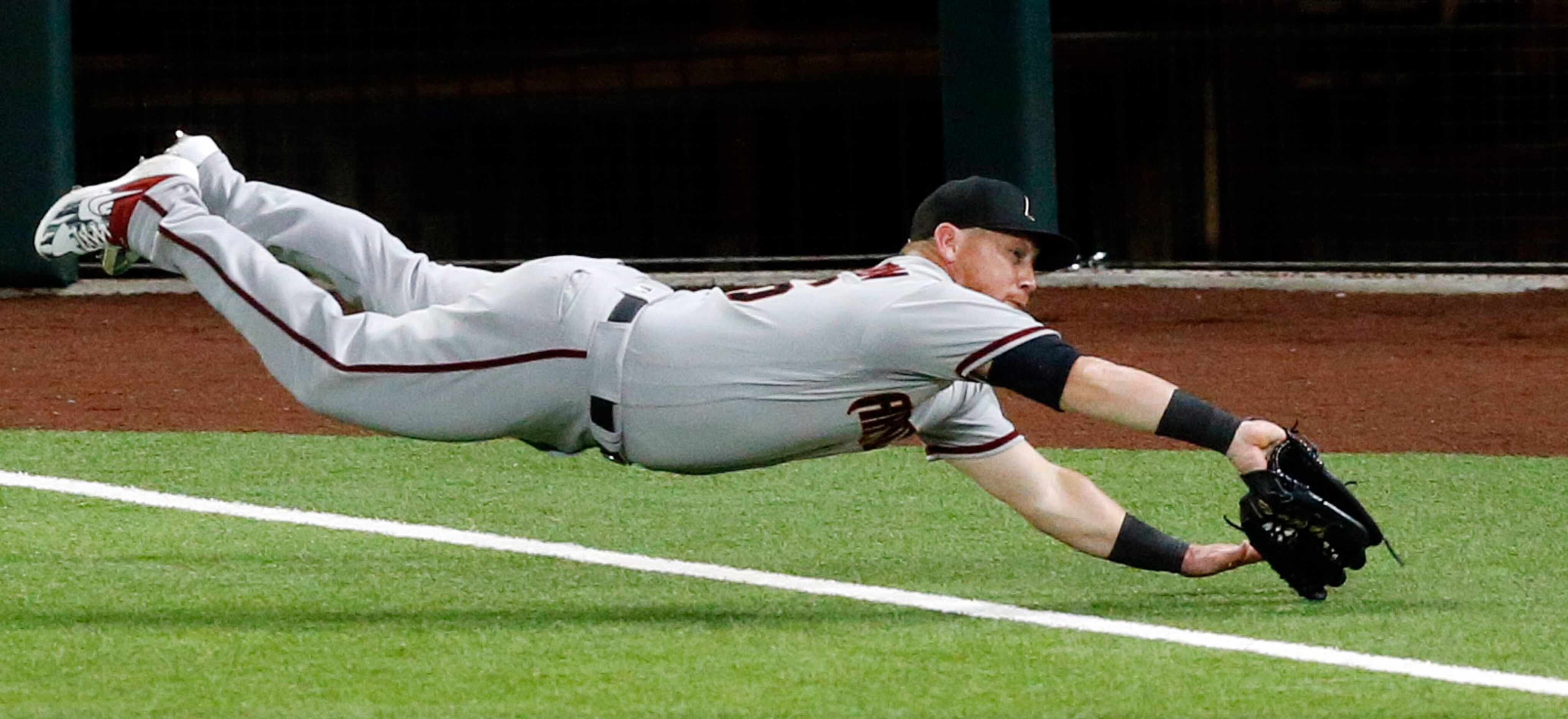 Arizona Diamondbacks right fielder Kole Calhoun (56) dives across the foul line for a pop up...