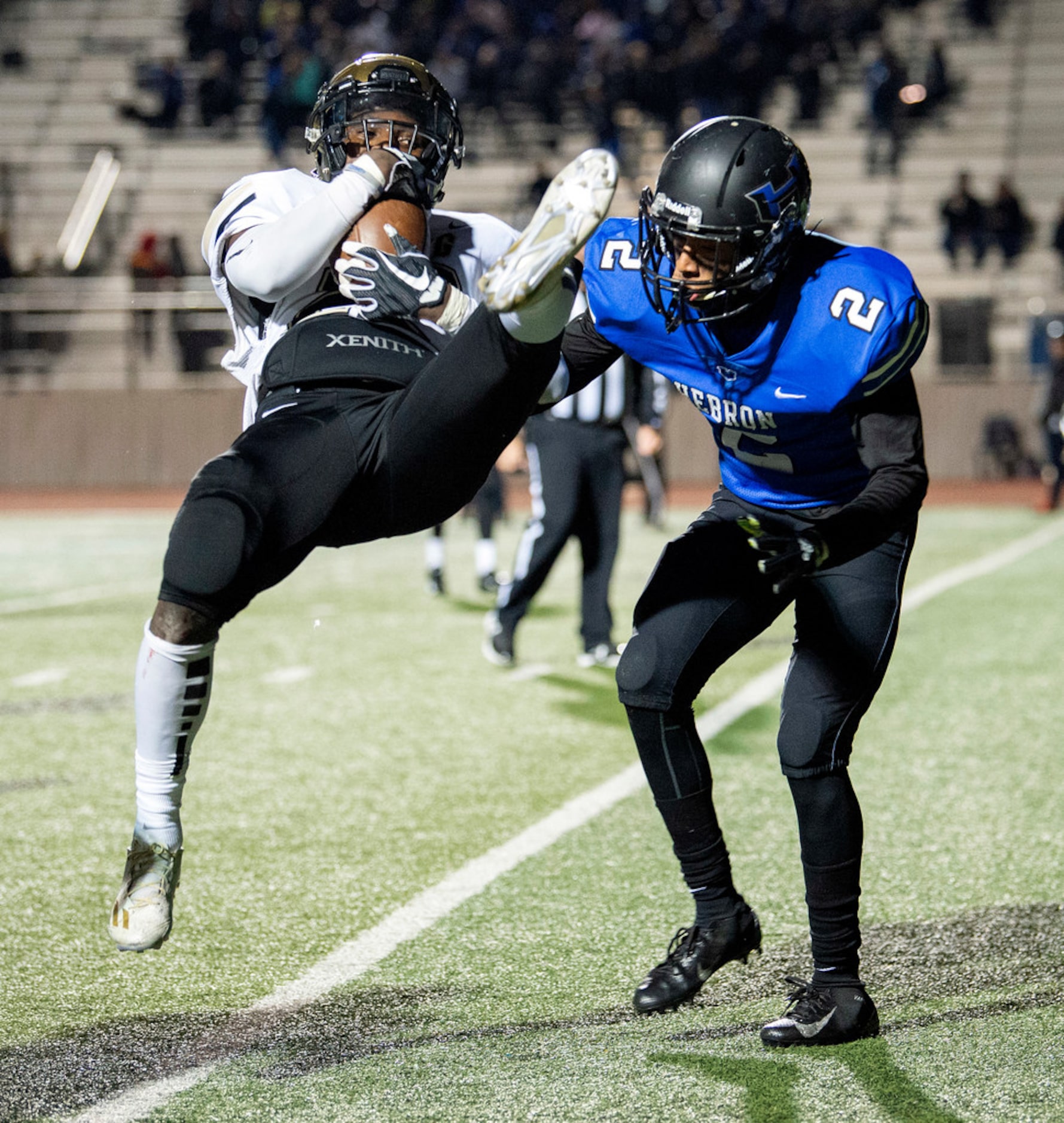 Irving senior running back Treyvon Jackson (22) goes airborne as he crosses the goal line in...