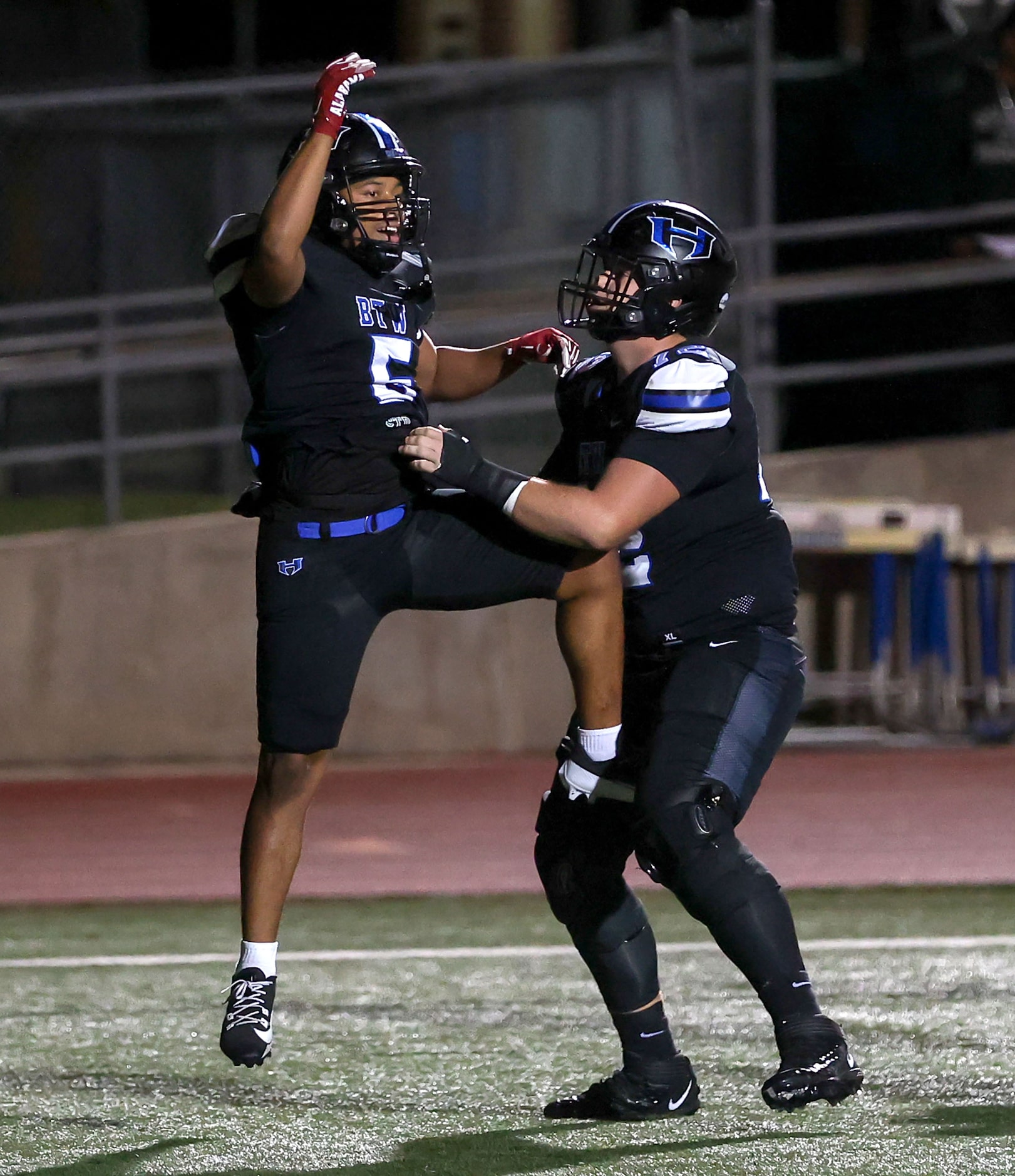 Hebron running back Ayson McCray Jones (5) celebrates with offensive lineman Drew Deason (R)...