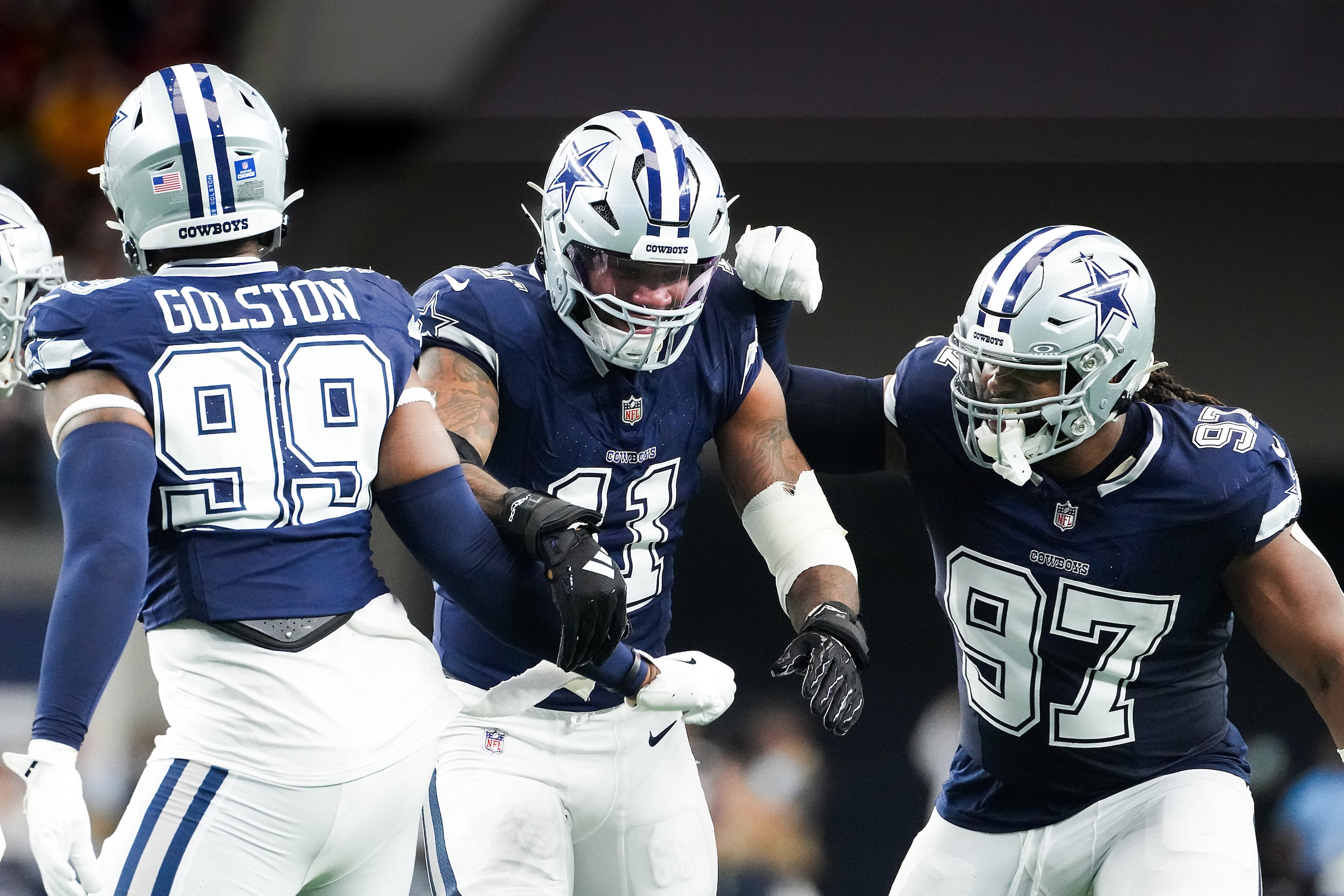 Dallas Cowboys linebacker Micah Parsons (11) celebrates with defensive end Chauncey Golston...