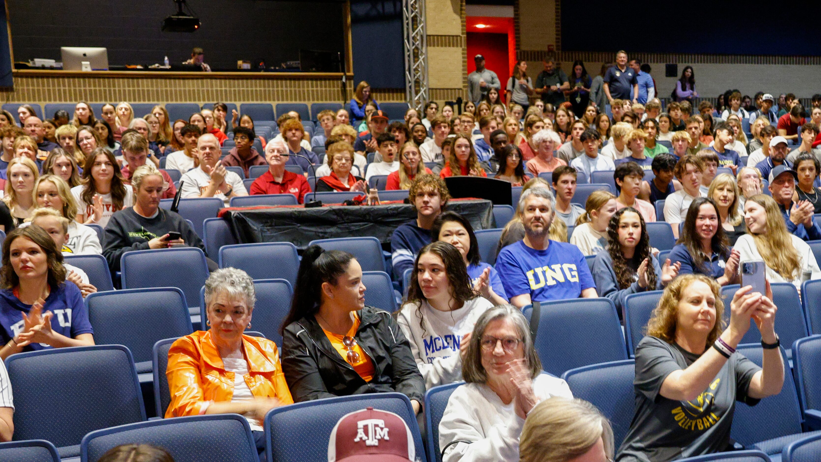 Keller students and family members clap during a national letter of intent signing ceremony...