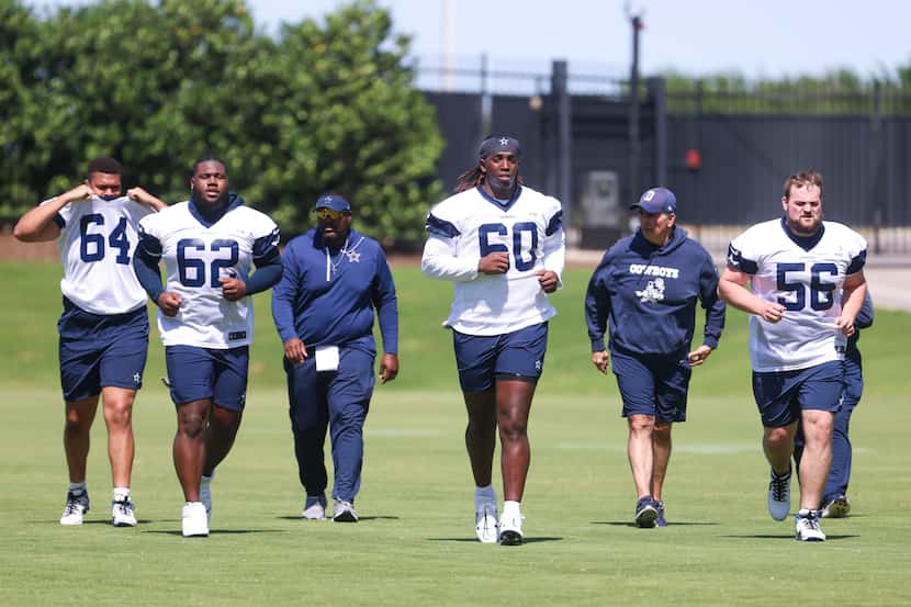 Dallas Cowboys offensive line Earl Bostick (64), Nathan Thomas (62), Tyler Guyton (60) and...