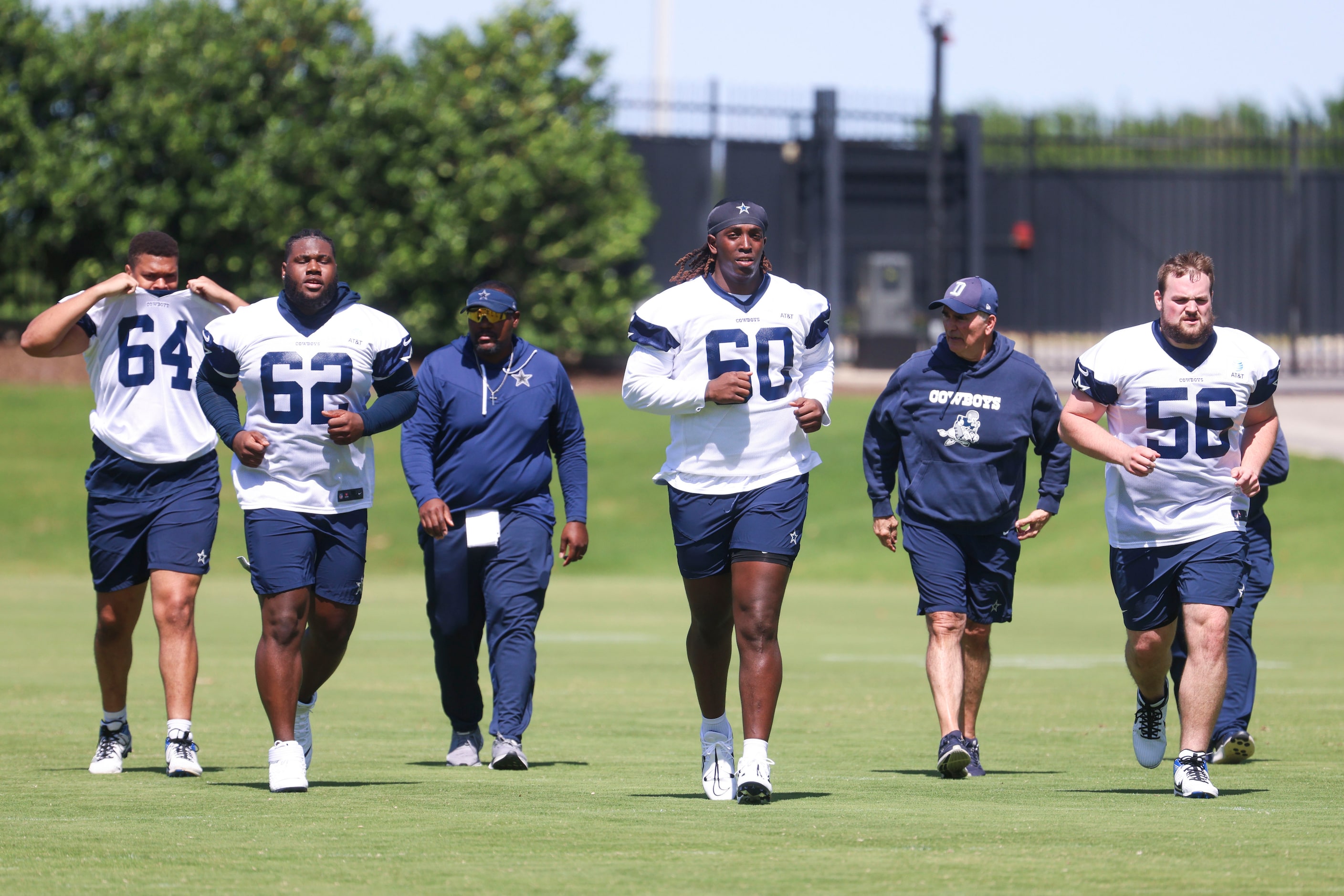 Dallas Cowboys offensive line Earl Bostick (64), Nathan Thomas (62), Tyler Guyton (60) and...