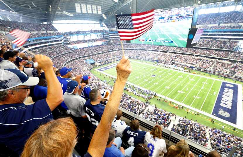 Dallas Cowboys fans waves their flags during the kickoff of the Cowboys season opener...