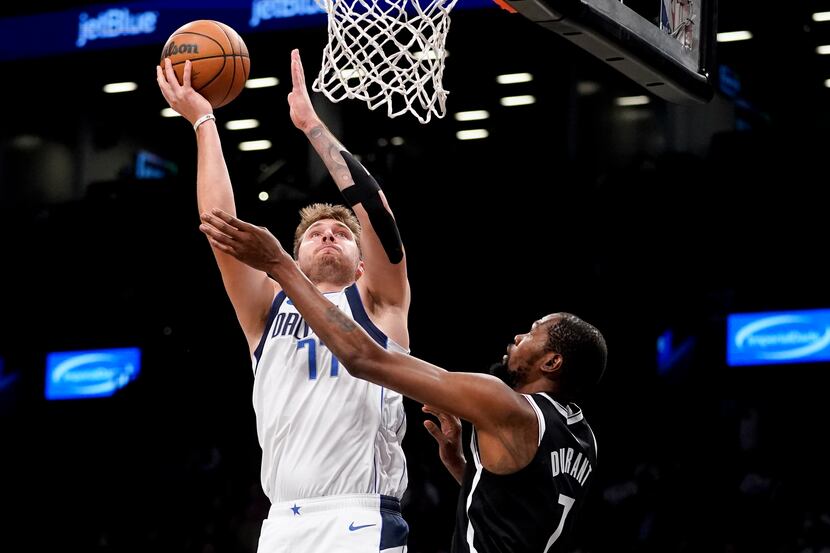Dallas Mavericks guard Luka Doncic (77) shoots against Brooklyn Nets forward Kevin Durant...