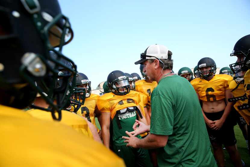 Rockport-Fulton head football coach Jay Seibert  talks to the team in a huddle during...