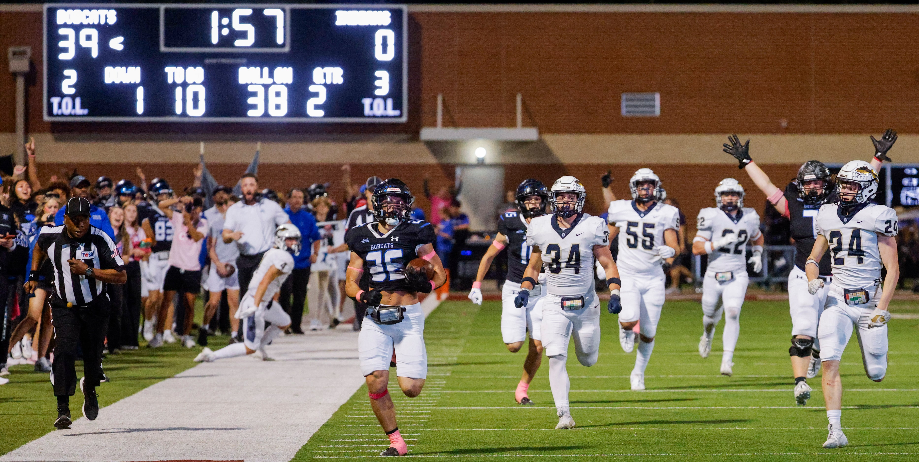 Byron Nelson’s Tucker James (26) runs past Keller high players as he scores a touchdown...