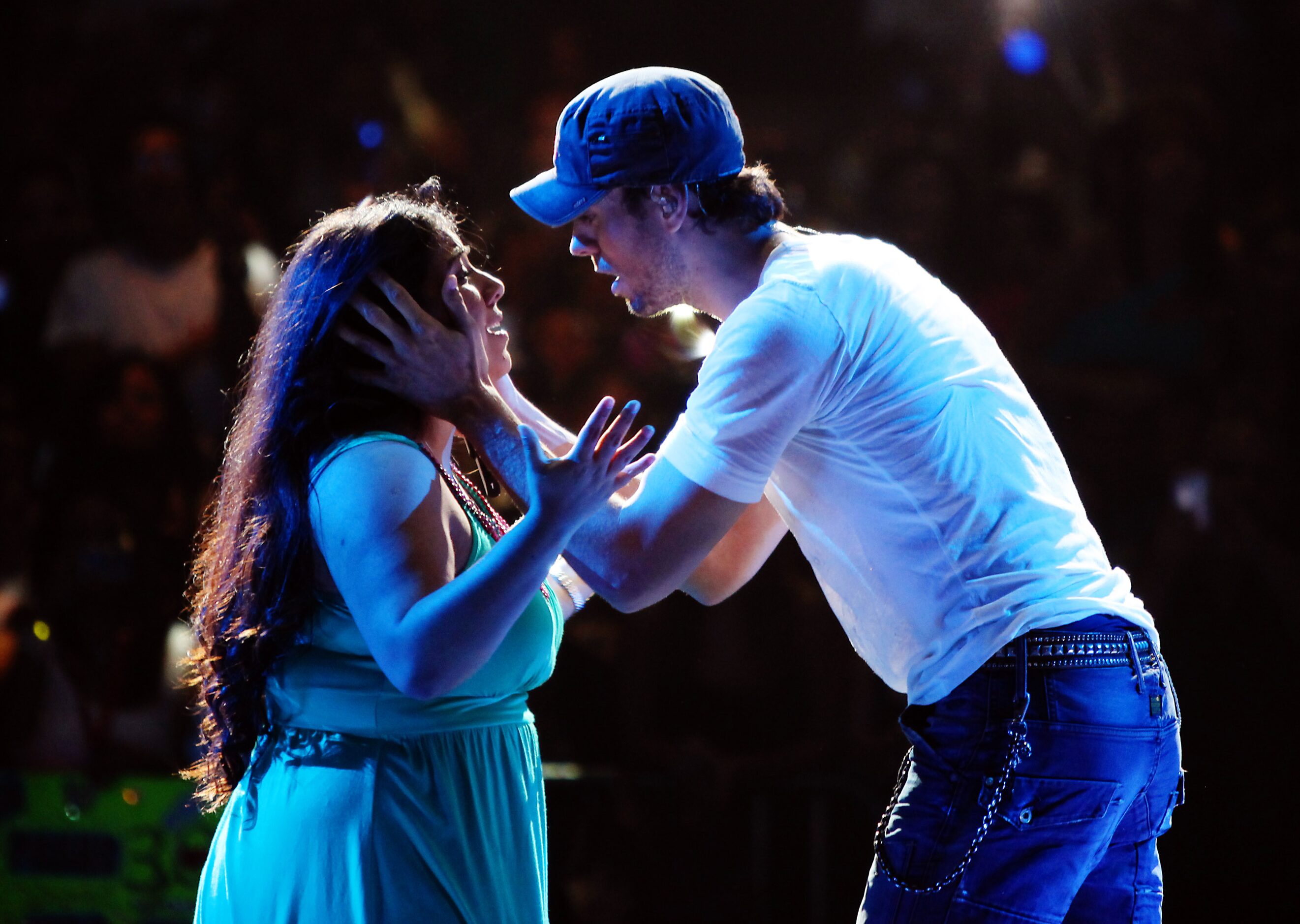 Enrique Iglesias serenades a young female fan after he chose her from the audience to join...