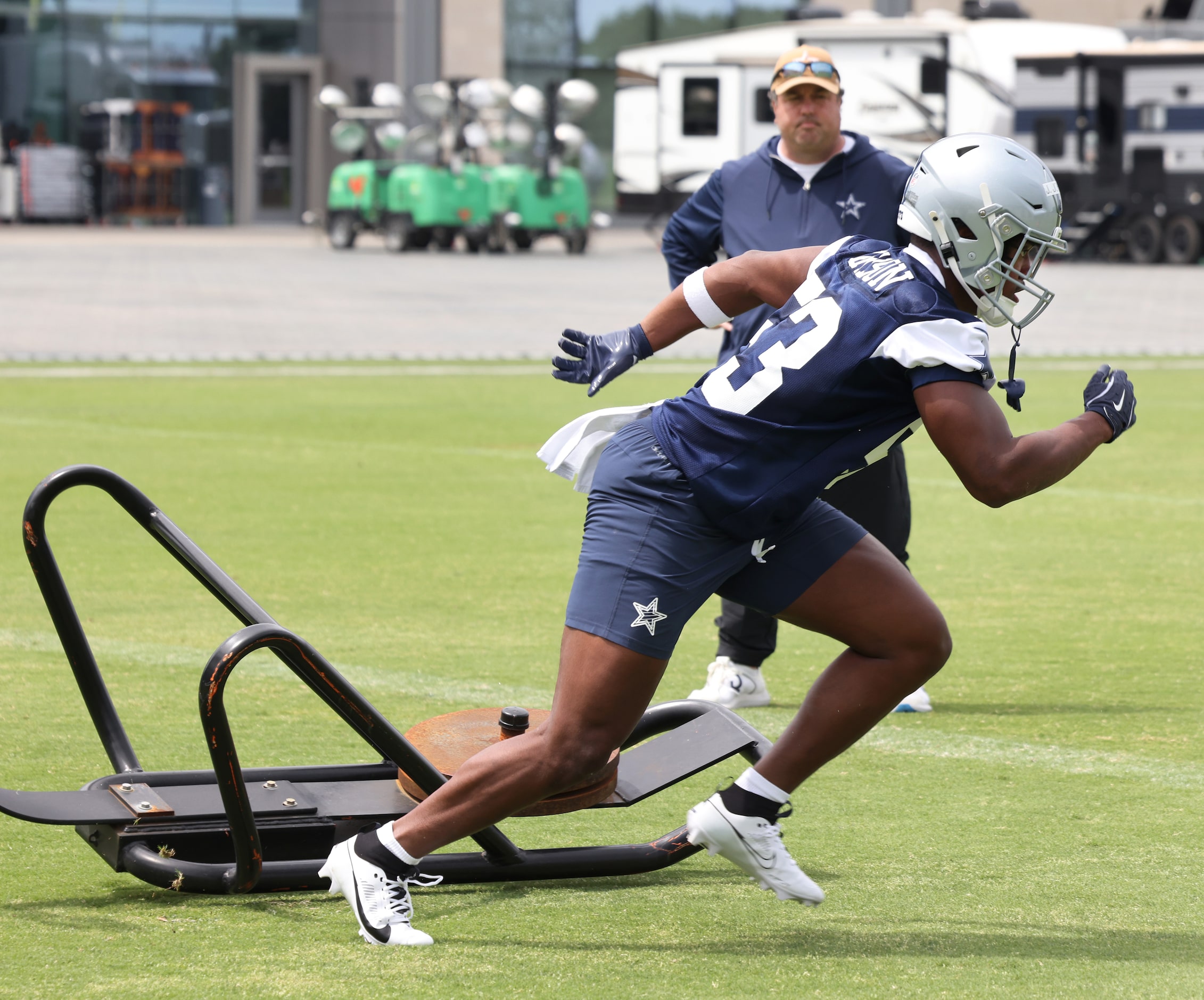 Dallas Cowboys linebacker Jason Johnson (53) bolts from a blocking sled as a staff member...