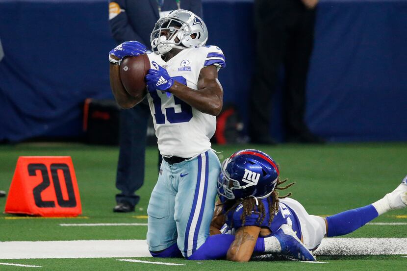 Dallas Cowboys wide receiver Michael Gallup (13) reaches back for a long pass completion...