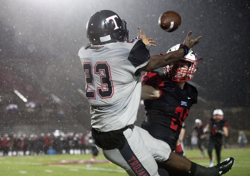 Euless Trinity junior wide receiver Gregg Garner (23) attempts to haul in a pass while...