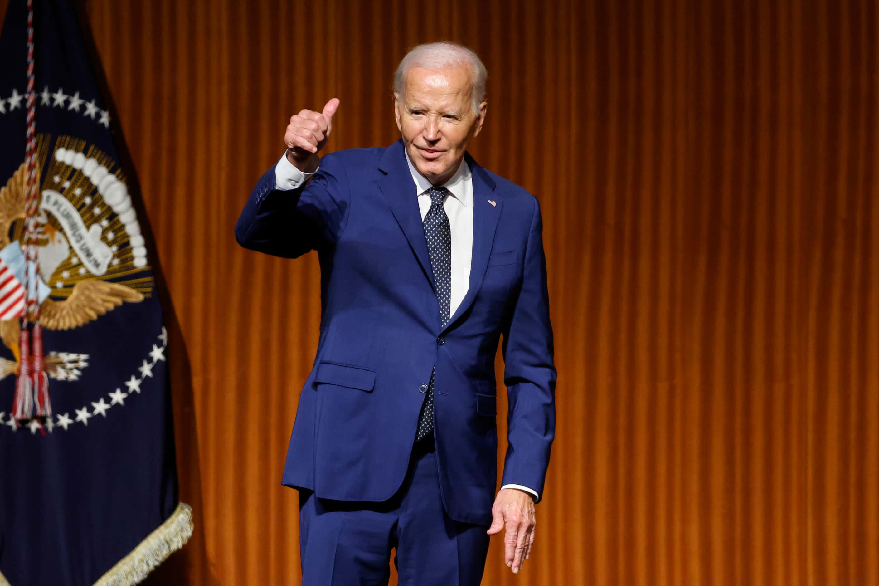 President Joe Biden gives a thumbs up after his speech during an event commemorating the...