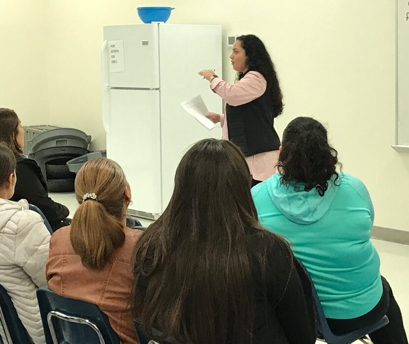 Lily Rodriguez, a volunteer with Dallas Area Interfaith, talks to parishioners at St. Philip...