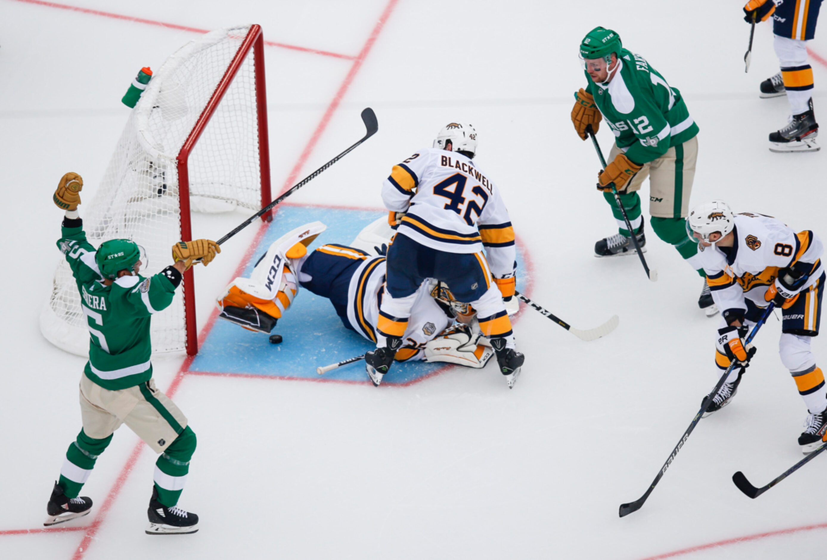 Dallas Stars defenseman Andrej Sekera (5) and center Radek Faksa (12) assist Dallas Stars...