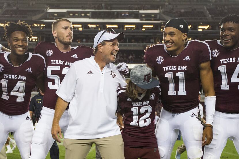 Texas A&M Aggies head coach Jimbo Fisher, joined by his son Ethan Fisher (wearing jersey...