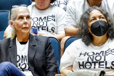 Neighbors Barbara Paige (left) and Dolores Serroka (right) listen to public comments at a...