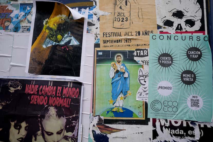 An image of soccer player Lionel Messi as a Saint is one of many items covering a street...