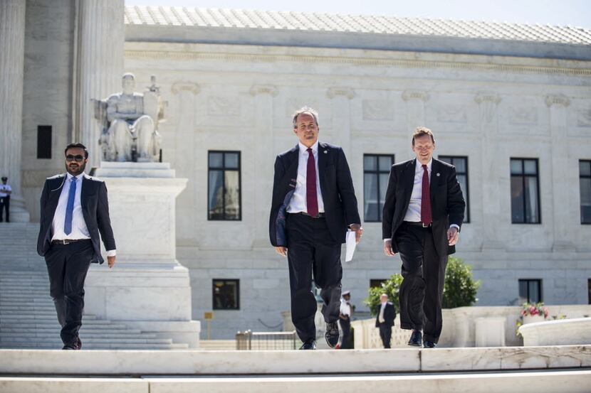 Texas Attorney General Ken Paxton (center)  walks to a news conference outside the Supreme...
