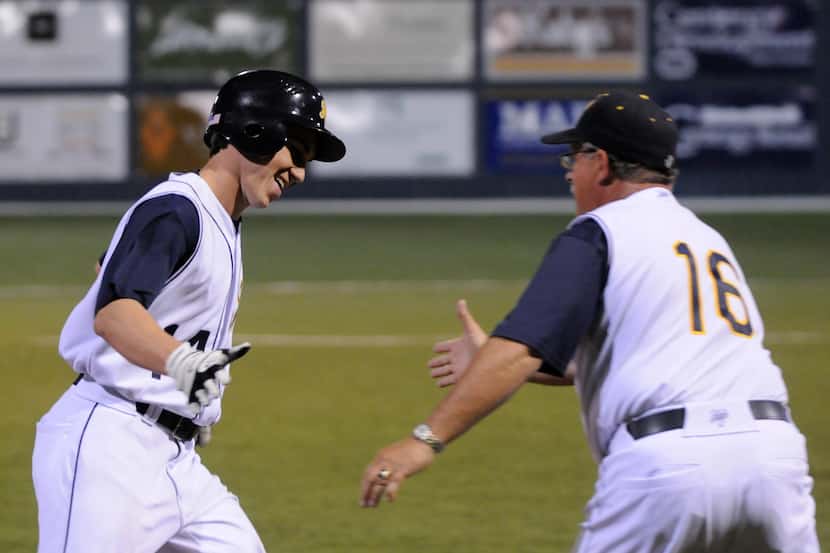 Highland Park's Jake Howeth, left, extends a hand to head baseball coach Fred Oliver after...