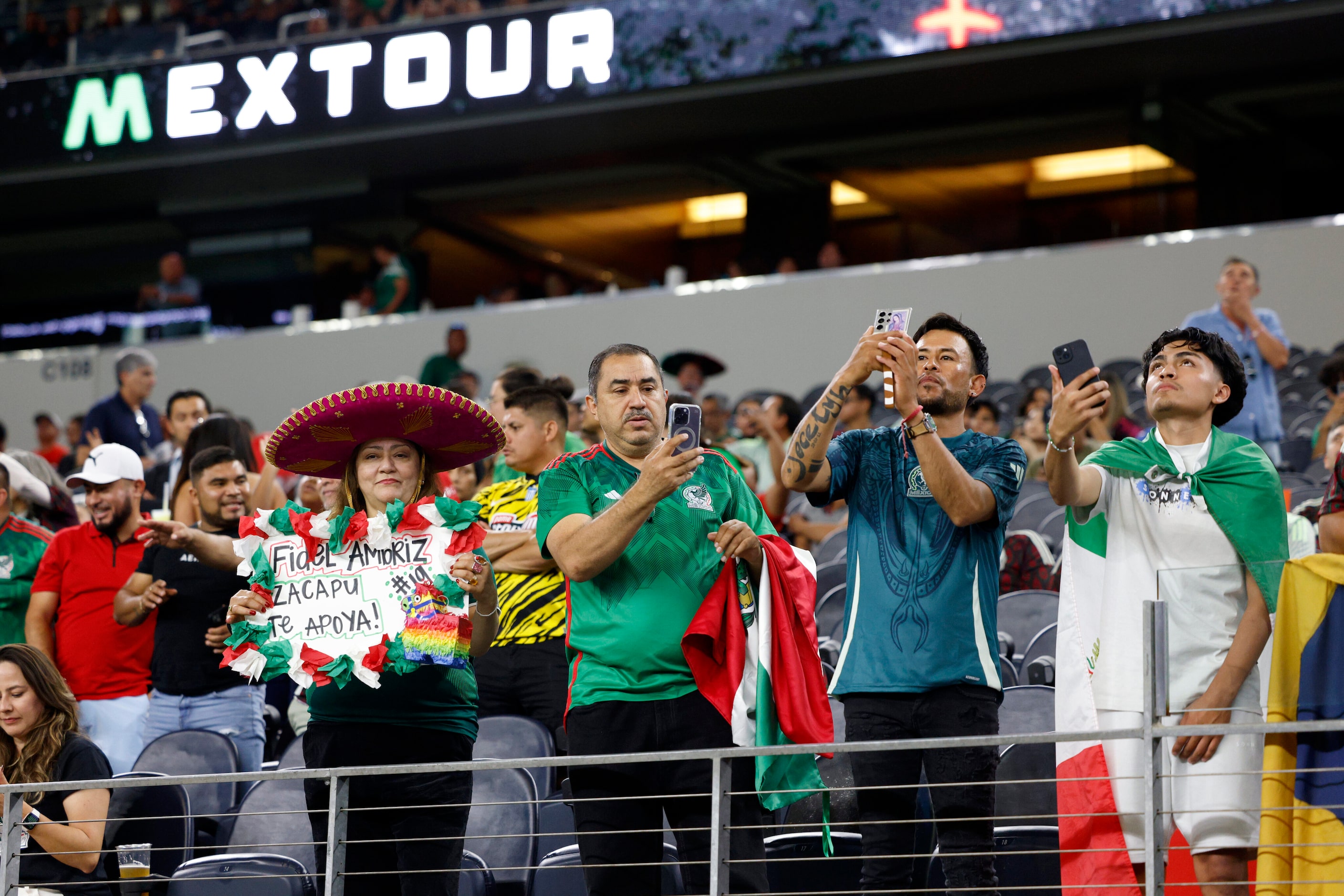 Mexico fans stand and take photos before the first half of an international friendly match...