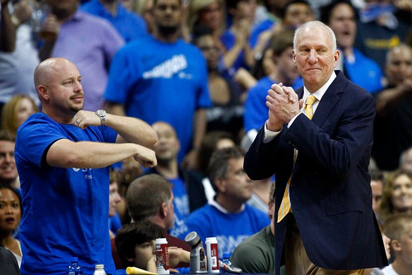 A Dallas Mavericks fans shows San Antonio Spurs head coach Gregg Popovich how his player...