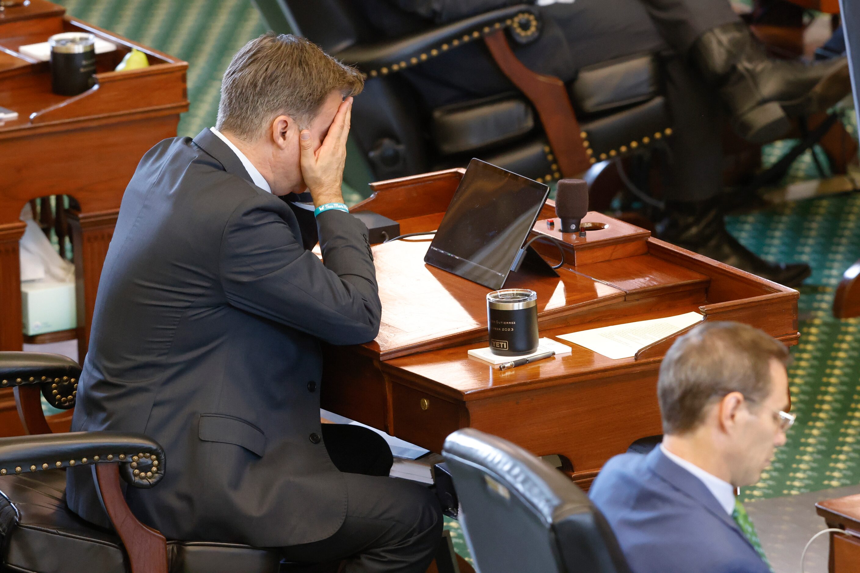 Texas Sen. Roland Gutierrez, D-San Antonio, rubs his face while listening to testimony...