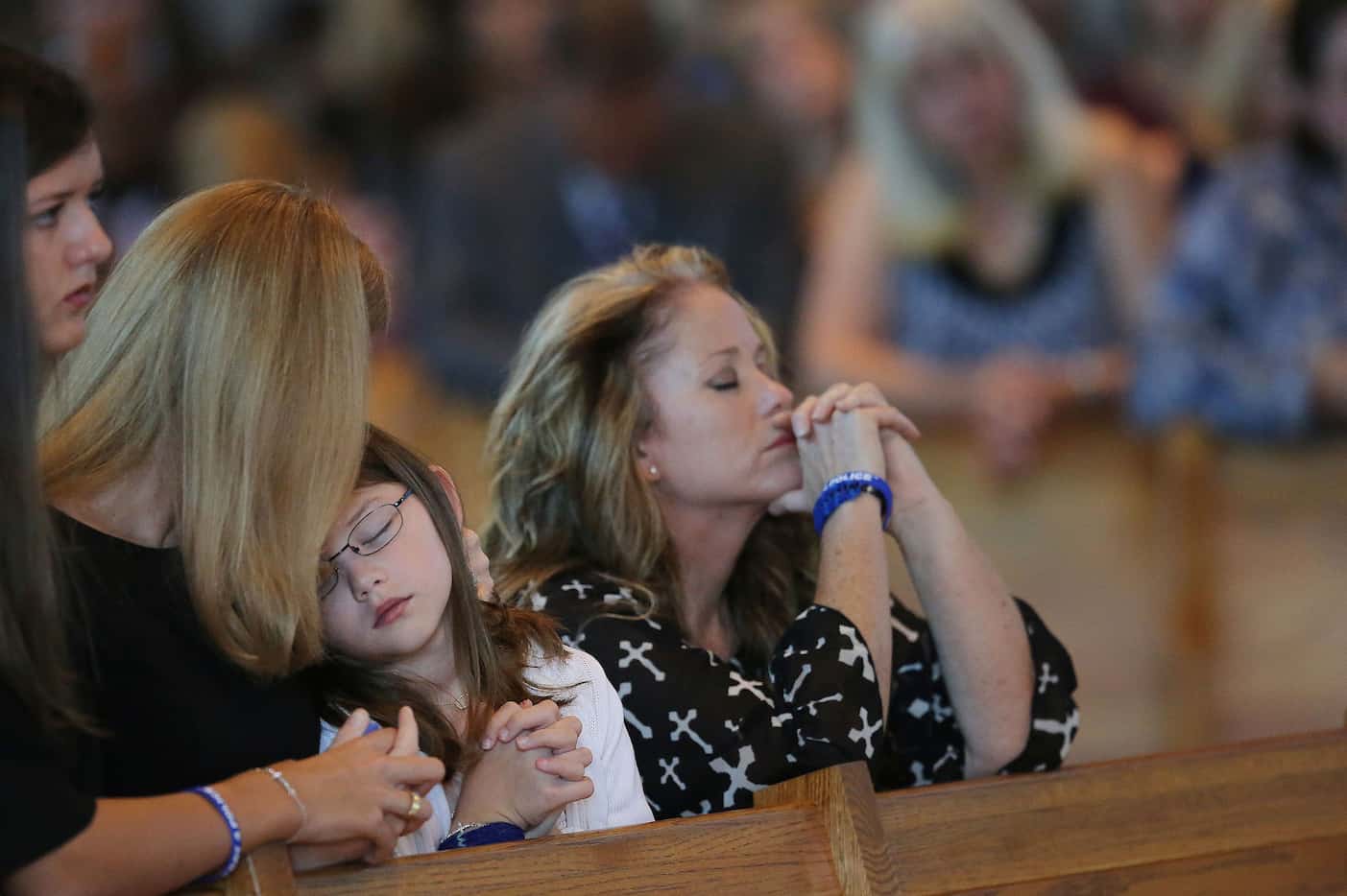 Heidi Smith (second to left) embraces her daughter, Caroline Smith, with her other daughter,...