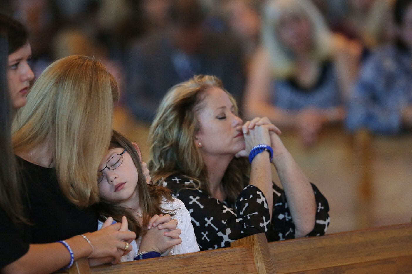 Heidi Smith (second to left) embraces her daughter, Caroline Smith, with her other daughter,...