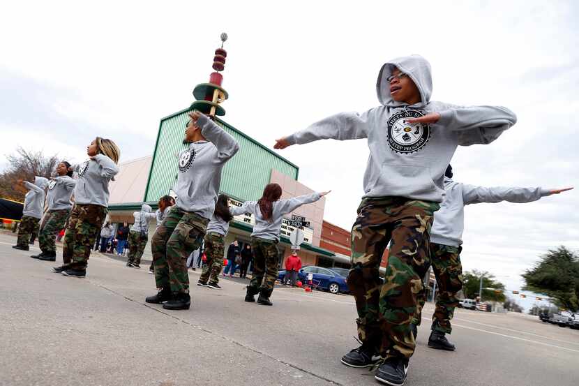 Members of the Garland High School step team, including Zavier Chatman (right) perform in...