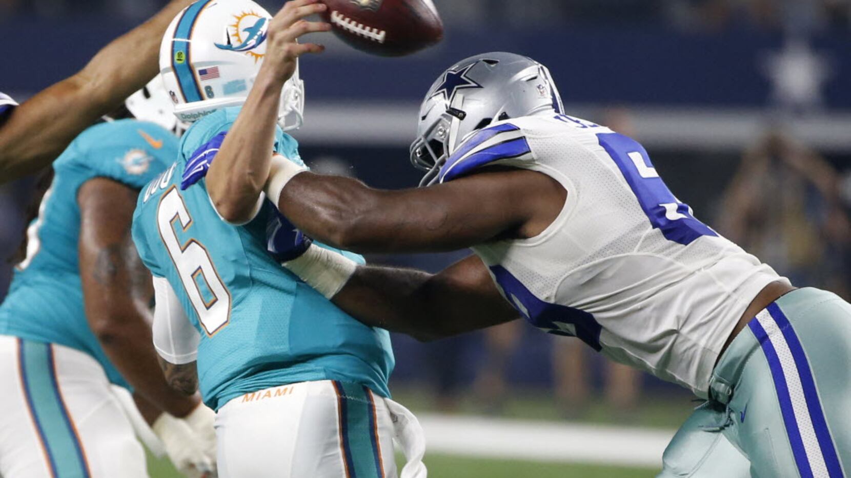 Miami Dolphins quarterback Brandon Doughty (6) fumbles the ball after being hit by Dallas...