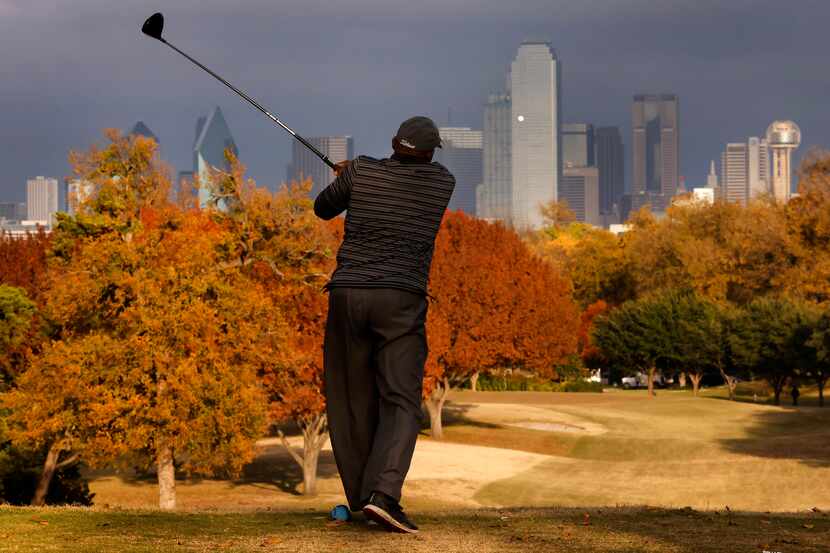 Fall color envelopes Stevens Park Golf Course in Dallas as Chester Tyson of DeSoto tees of...