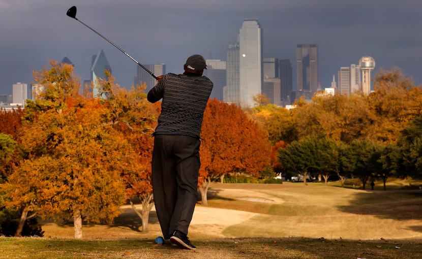 Fall color envelopes Stevens Park Golf Course in Dallas as Chester Tyson of DeSoto tees of...