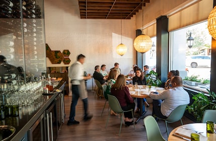 Business colleagues chat during the lunch hour at Sachet, a Mediterranean restaurant in...